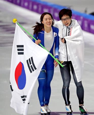 Feb 18, 2018; Pyeongchang, South Korea; Sang-Hwa Lee (KOR) celebrates winning silver and Nao Kodaira (JPN) celebrates winning gold in the womenâ€™s speed skating 500m during the Pyeongchang 2018 Olympic Winter Games at Gangneung Ice Arena. Mandatory Credit: Mark Hoffman-USA TODAY Sports