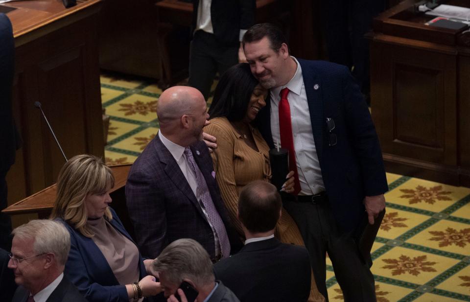 Tennessee Rep. Johnny Garrett, R- Goodlettsville talks with Sen. London Lamar D-Memphis, while Rep. Jeremy Faison, R- Cosby greets her with a hug during a recess on the house floor on the last day of session at Tennessee State Capitol Building  in Nashville , Tenn., Friday, April 21, 2023. 