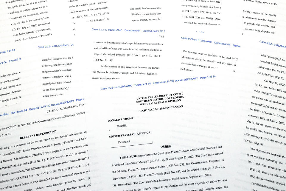 Pages from the order granting a request by former President Donald Trump's legal team to appoint a special master to review documents seized by the FBI during a search of his Mar-a-Lago estate is photographed Monday, Sept. 5, 2022. (Jon Elswick/AP Photo)