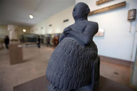 A black basalt statue of Dudu, the famous Sumerian scribe, dating from the early dynasty of Lagash in 2400 B.C. is displayed at the National Museum of Iraq in Baghdad December 31, 2013. REUTERS/Ahmed Saad