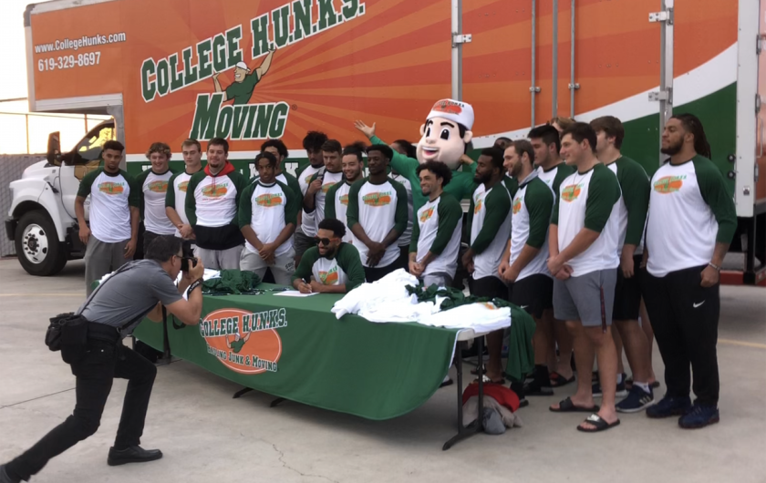 San Diego State players participate in an NIL event with College HUNKS Hauling Junk and Moving.