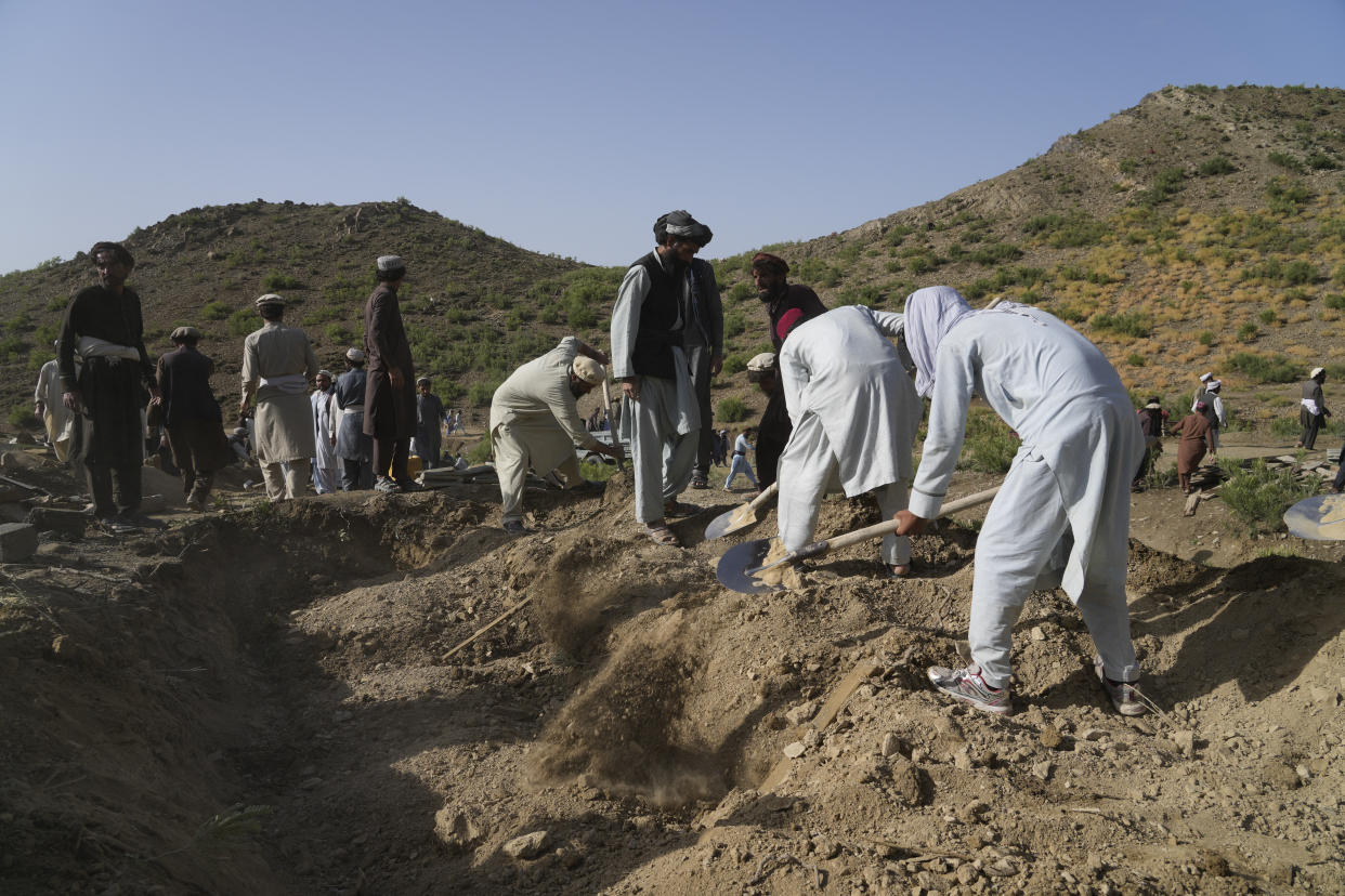 Afghans burry relatives killed in an earthquake to a burial site l in Gayan village, in Paktika province, Afghanistan, Thursday, June 23, 2022. A powerful earthquake struck a rugged, mountainous region of eastern Afghanistan early Wednesday, flattening stone and mud-brick homes in the country's deadliest quake in two decades, the state-run news agency reported. (AP Photo/Ebrahim Nooroozi)