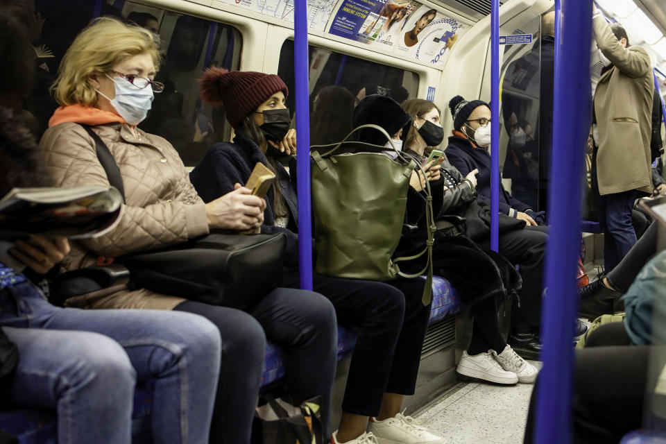 Passengers are seen wearing face masks on the London Underground after Sadiq Khan declared a major incident in the capital following a surge in Omicron cases. (Getty Images)