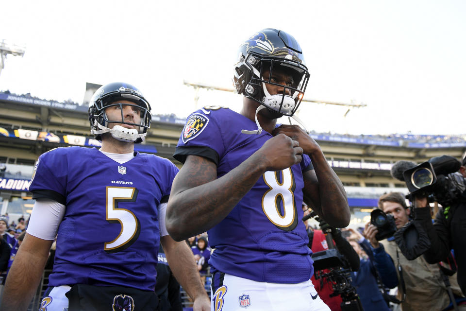 Baltimore Ravens quarterbacks Lamar Jackson (8) and Joe Flacco walk onto the field before an NFL wild card playoff football game against the Los Angeles Chargers, Sunday, Jan. 6, 2019, in Baltimore. (AP Photo/Nick Wass)