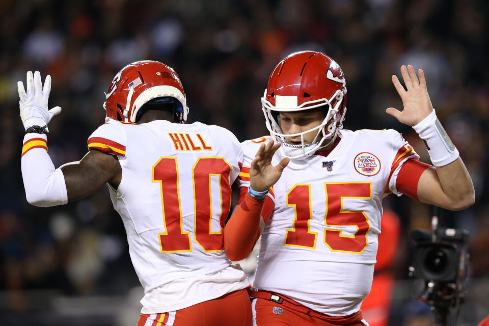 Quarterback Patrick Mahomes #15 of the Kansas City Chiefs celebrates with teammate wide receiver Tyreek Hill #10 