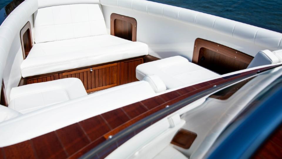 Janet Gretzky designed the interior in all white, a nice contrast with the dark red wood of the boat. - Credit: Courtesy Coeur Custom