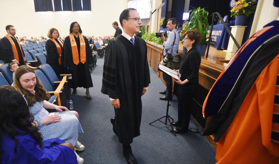 Pennsylvania Governor Josh Shapiro, center, takes the stage to help begin the Erie County Community College graduation ceremony  on June 3.