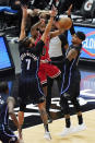 Chicago Bulls guard Coby White, center, passes the ball against Orlando Magic guard Michael Carter-Williams, left, and guard Gary Harris during the first half of an NBA basketball game in Chicago, Wednesday, April 14, 2021. (AP Photo/Nam Y. Huh)