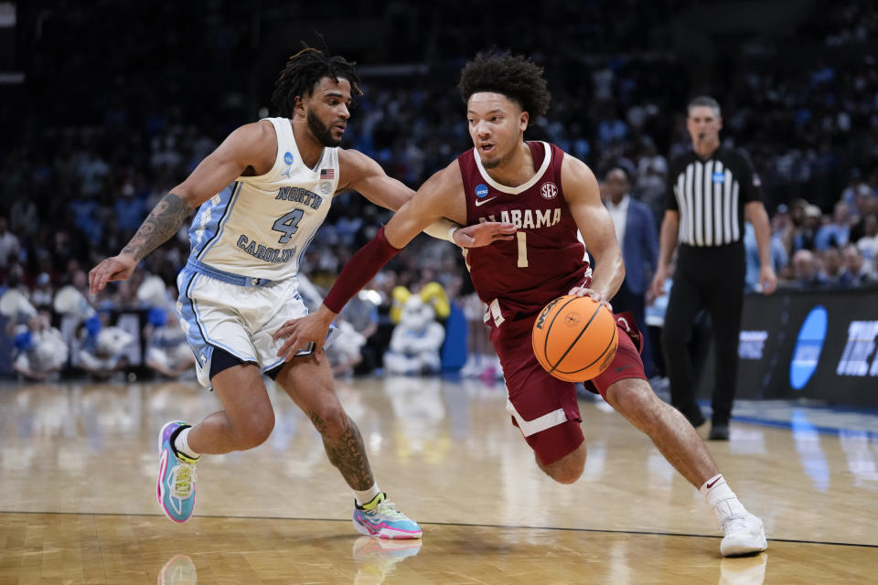 Alabama guard Mark Sears (1) is defended by North Carolina guard RJ Davis during the second half of a Sweet 16 college basketball game in the NCAA tournament Thursday, March 28, 2024, in Los Angeles. (AP Photo/Ashley Landis)