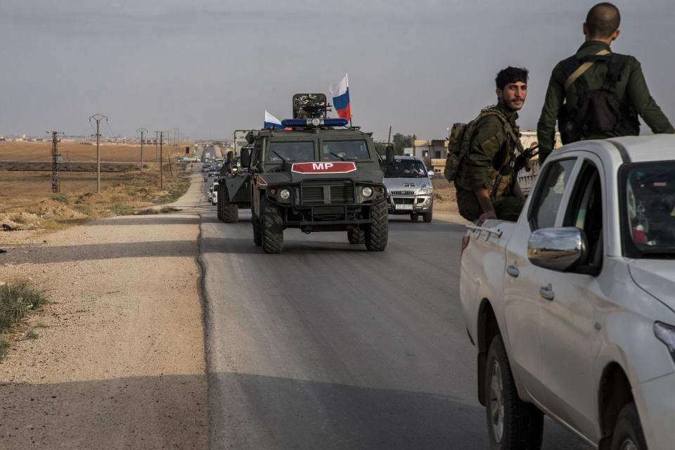 Russian forces patrol near the city of Qamishli, north Syria, Thursday, Oct. 24, 2019. Syrian forces, Russian military advisers and military police are being deployed in a zone 30 kilometers (19 miles) deep along much of the northeastern border, under an agreement reached Tuesday by Russia and Turkey. (AP Photo/Baderkhan Ahmad)