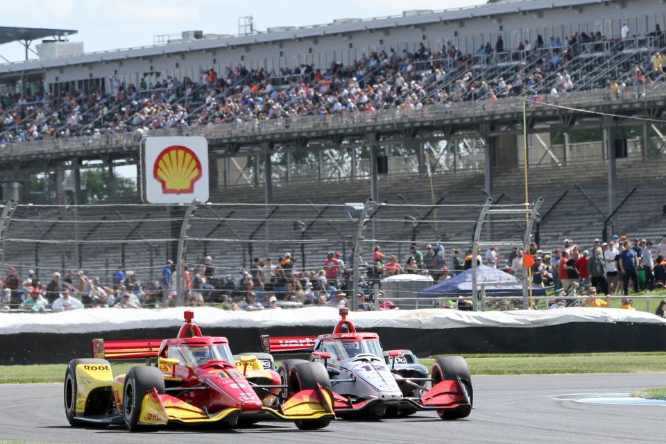 Chip Ganassi Racing driver Alex Palou (10) and Team Penske driver Will Power (12) move through a turn Saturday, May 11, 2024, during the Sonsio Grand Prix at Indianapolis Motor Speedway.