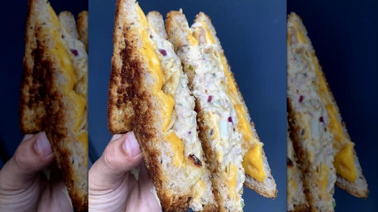 Diagonal cut tuna melt being held