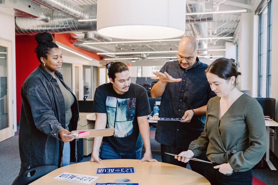 Umari Osgood, Sabian Samaniego, Mark Palomino and Nina Kalpakis work on Tennessee's new license plate designs.