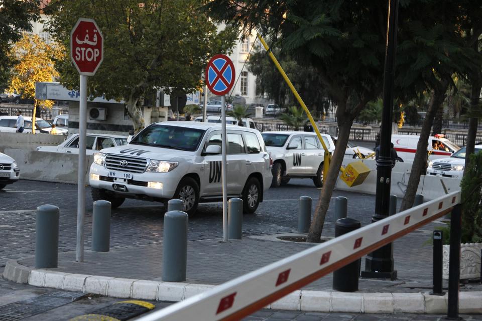 U.N. vehicles transporting a team of experts from the Organization for the Prohibition of Chemical Weapons (OPCW) return to their hotel in Damascus October 6, 2013. The team of international experts began the process of destroying Syria's chemical gas arsenal on Sunday, an official on the mission said. The official declined to give more details. Witnesses said the experts left their Damascus hotel in the early hours on Sunday for an unknown location. REUTERS/Khaled al-Hariri (SYRIA - Tags: POLITICS CONFLICT CIVIL UNREST)