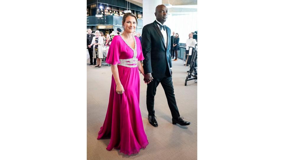 Princess Martha-Louise and Durek Verrett holding hands in smart dress