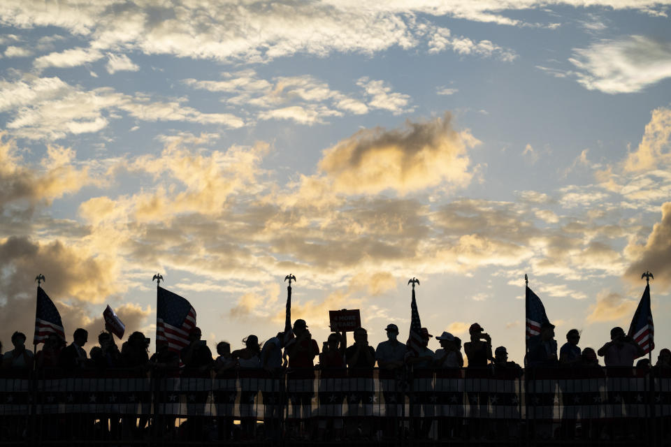 Supporters of President Donald Trump cheer as he arrives for a campaign rally at Cecil Airport, Thursday, Sept. 24, 2020, in Jacksonville, Fla. (AP Photo/Evan Vucci)