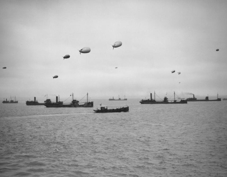 A convoy of merchantmen and colliers protected by warships of the Royal Navy and anti aircraft barrage balloons assemble off the North West Coast of England ready to depart on 17th July 1942. (Photo by Central Press/Hulton Archive/Getty Images)