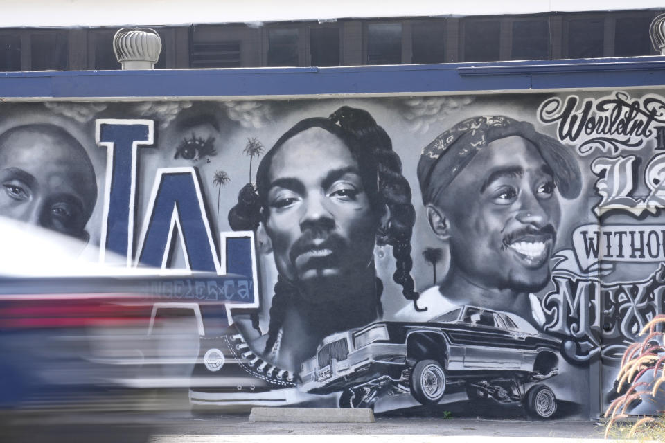 A portion of a mural by artist sloe_motions depicting Kobe Bryant, Snoop Dogg, and Tupac Shakur is seen on the side of Speedy Auto Tint on Friday, Sept. 29, 2023, in Bellflower, Calif. (AP Photo/Chris Pizzello)