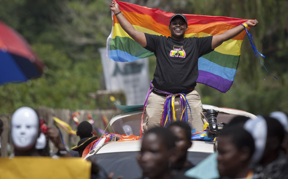 Ugandans take part in the 3rd Annual Lesbian, Gay, Bisexual and Transgender (LGBT) Pride celebrations in Entebbe, Uganda, Saturday, Aug. 9, 2014.  Scores of Ugandan homosexuals and their supporters are holding a gay pride parade on a beach in the lakeside town of Entebbe. The parade is their first public event since a Ugandan court invalidated an anti-gay law that was widely condemned by some Western governments and rights watchdogs.(AP Photo/Rebecca Vassie)