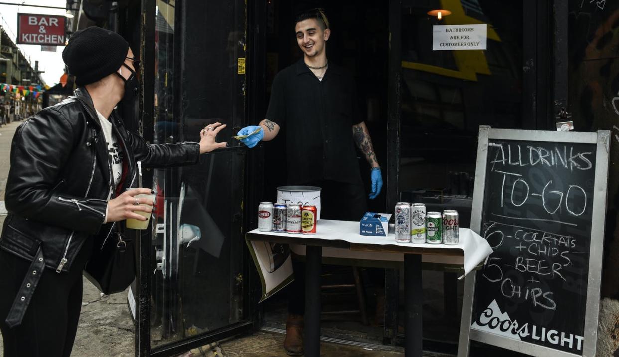 <span class="caption">A patron buys a frozen margarita to go in New York City April 2, 2020. Is the quarnatini a safer option? </span> <span class="attribution"><a class="link " href="https://www.gettyimages.com/detail/news-photo/cocktails-are-for-sale-to-go-at-caffe-dante-bar-and-news-photo/1207672467?adppopup=true" rel="nofollow noopener" target="_blank" data-ylk="slk:Getty Images/Stephanie Keith;elm:context_link;itc:0;sec:content-canvas">Getty Images/Stephanie Keith</a></span>