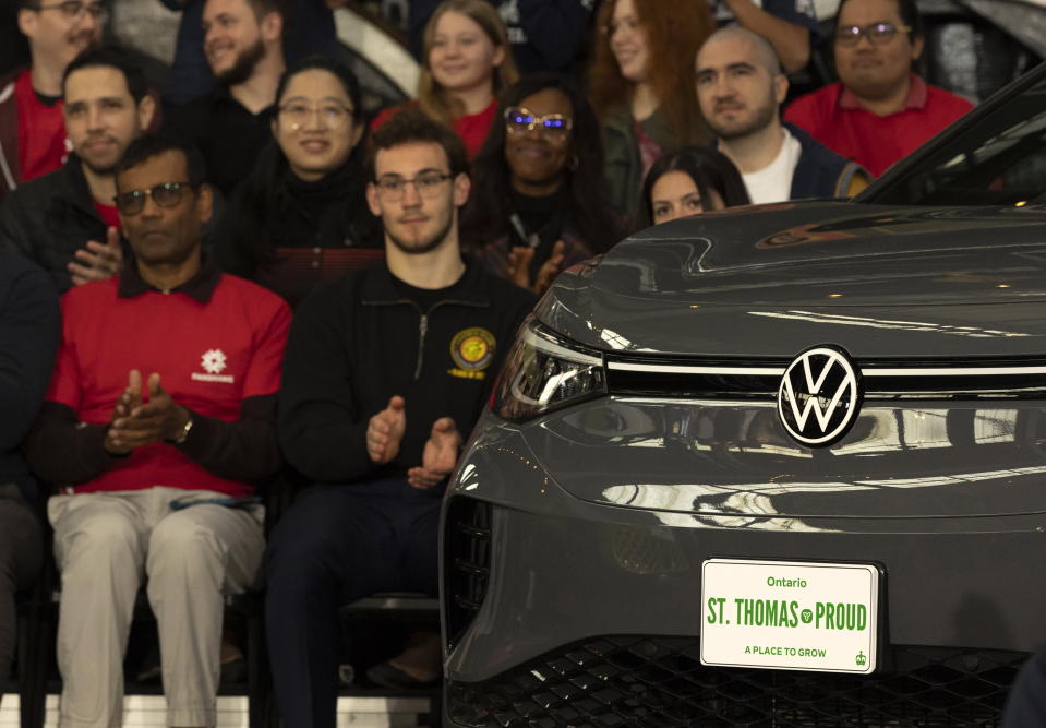 People look on as plans to build a Volkswagen electric vehicle battery plant in St. Thomas, Ontario, are announced at the Elgin County Railway Museum, Friday, April 21, 2023. (Tara Walton/The Canadian Press via AP)