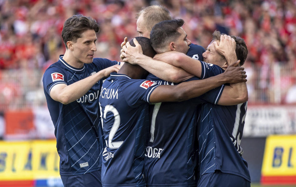 Philipp Hofmann, centre, of VfL Bochum celebrates with teammates after scoring their side's fourth goal of the game during the Bundesliga soccer match between 1. FC Union Berlin and VfL Bochum, at the An der Alten Forsterei stadium in Berlin, Germany, Sunday May 5, 2024. (Andreas Gora/dpa via AP)