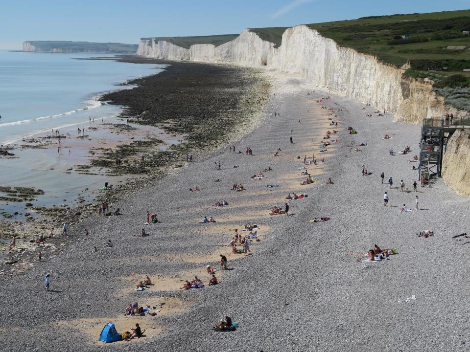 People enjoy the good weather on a beach near Eastbourne, Sussex, on 20 May, 2020: Mike Hewitt/Getty Images