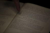 Roni Gross, curator of the Hebrew University's Albert Einstein Archive, points at original documents related to Albert Einstein's hypothesis of the existence of gravitational waves during a news conference in Jerusalem February 11, 2016. REUTERS/Ronen Zvulun