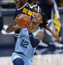 Memphis Grizzlies guard Ja Morant, right, drives to the rim past Denver Nuggets forward Will Barton, left, in the first half of an NBA basketball game Monday, April 19, 2021, in Denver. (AP Photo/David Zalubowski)