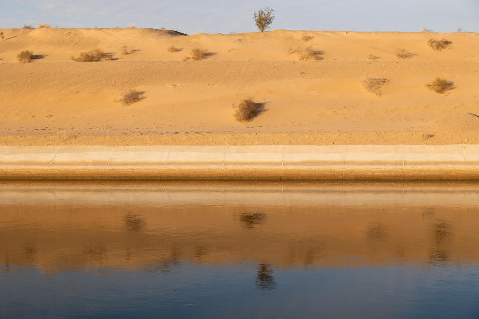 The All American Canal flows past the Imperial Sand Dunes near Felicity, California, U.S., December 5, 2022. REUTERS/Caitlin Ochs