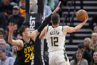 Milwaukee Bucks guard Grayson Allen (12) goes to the basket as Utah Jazz center Walker Kessler (24) defends during the first half of an NBA basketball game Friday, March 24, 2023, in Salt Lake City. (AP Photo/Rick Bowmer)