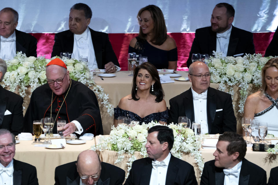 Keynote speaker Ambassador to the United Nations Nikki Haley, center, shares a light moment as she attends the 73rd Annual Alfred E. Smith Memorial Foundation Dinner Thursday, Oct. 18, 2018, in New York. Left is Archbishop of New York Cardinal Timothy Dolan, and right is Michael Haley, husband of Nikki Haley. (AP Photo/Craig Ruttle)