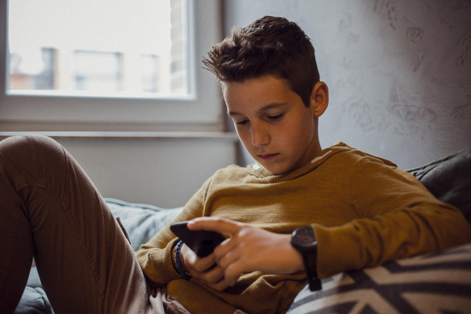 Teenager relaxing in his bedroom