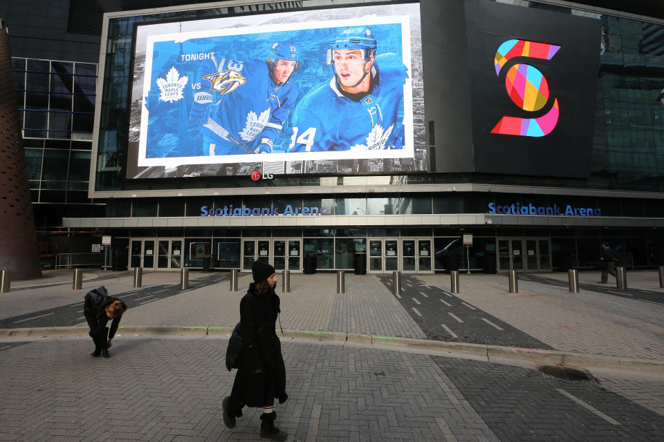 TORONTO, ON- MARCH 12  - Fans and  commuters walk past Scotiabank Arena where the Toronto Maple Leafs and the Nashville Predators were supposed to play tonight. The NHL along with the NBA, MLB, NLS and MLS have suspended all games in order to slow the spread of COVID-19 in Toronto. March 12, 2020.        (Steve Russell/Toronto Star via Getty Images)