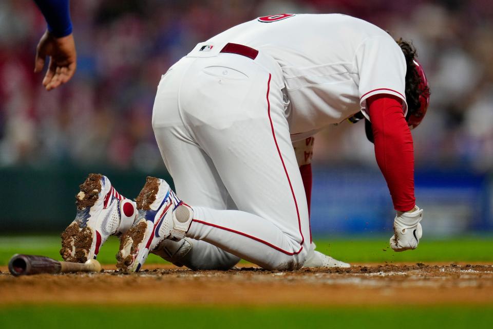 Cincinnati Reds second baseman Jonathan India drops to his knees after a foul ball bounces off his foot. Throughout last season, India set the standard by showing his toughness on the field.