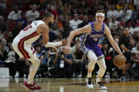 Sacramento Kings guard Kevin Huerter (9) takes the ball downcourt against Miami Heat forward Caleb Martin (16) during the first half of an NBA basketball game, Wednesday, Nov. 2, 2022, in Miami. (AP Photo/Wilfredo Lee)