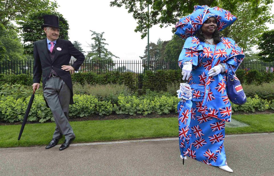 RNPS - PICTURES OF THE YEAR 2013 - A racegoer wearing a Union flag-inspired outfit arrives for Ladies' Day at the Royal Ascot horse-racing festival at Ascot, southern England June 20, 2013. REUTERS/Toby Melville (BRITAIN - Tags: SPORT HORSE RACING SOCIETY FASHION TPX)