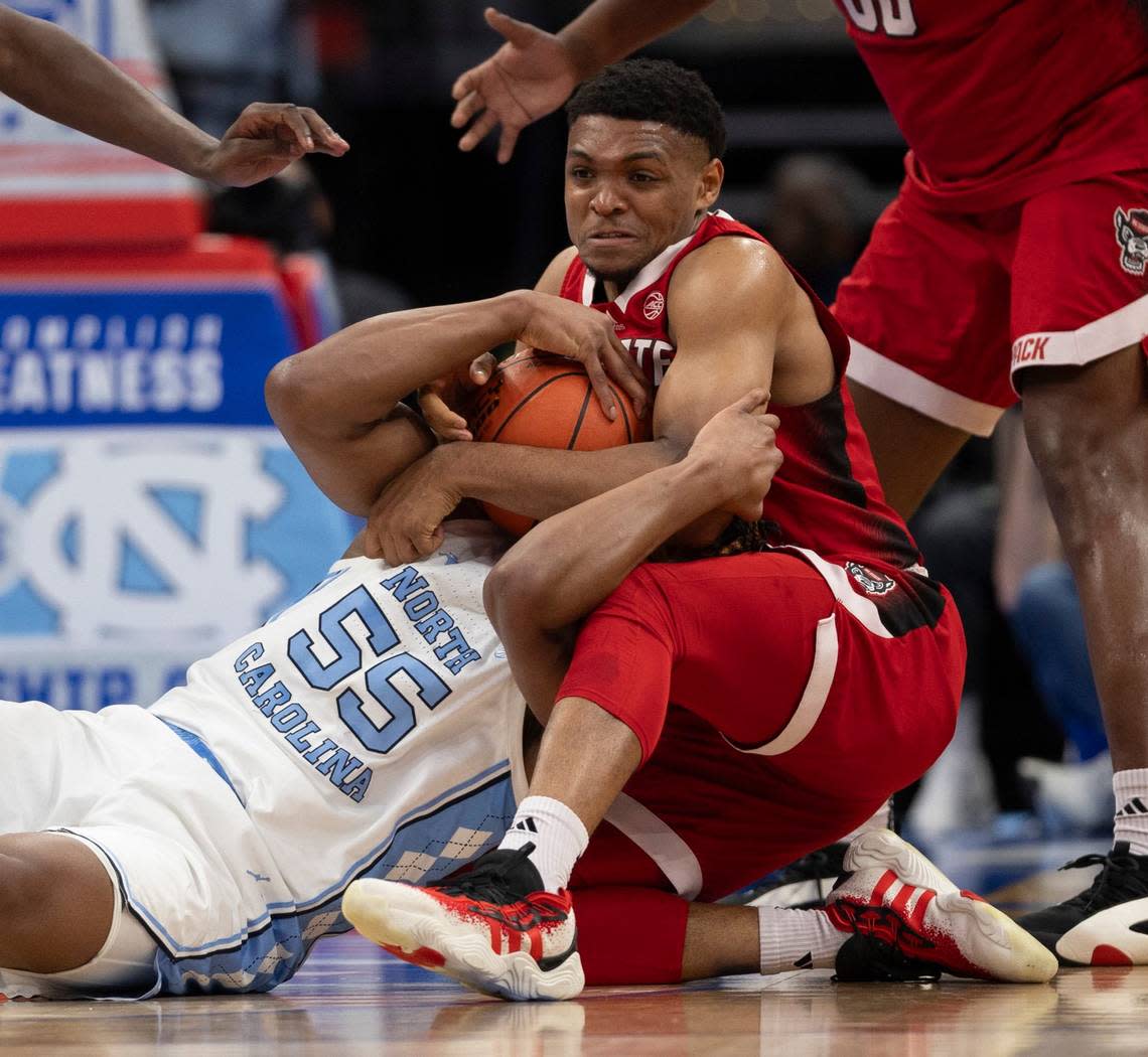 N.C. State’s Casey Morsell (14) ties up North Carolina’s Harrison Ingram (55) in a battle for a close ball in the first half during the ACC Men’s Basketball Tournament Championship at Capitol One Arena on Saturday, March 16, 2024 in Washington, D.C.
