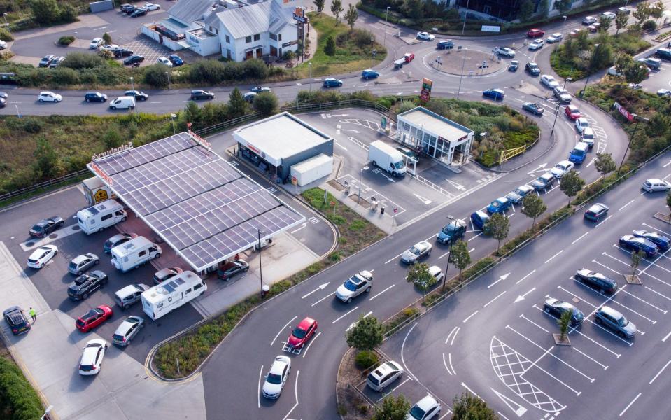 Vehicles queue for fuel at a Sainsbury's petrol station on September 24, 2021 in Weymouth, England - Finnbarr Webster /Getty Images Europe 