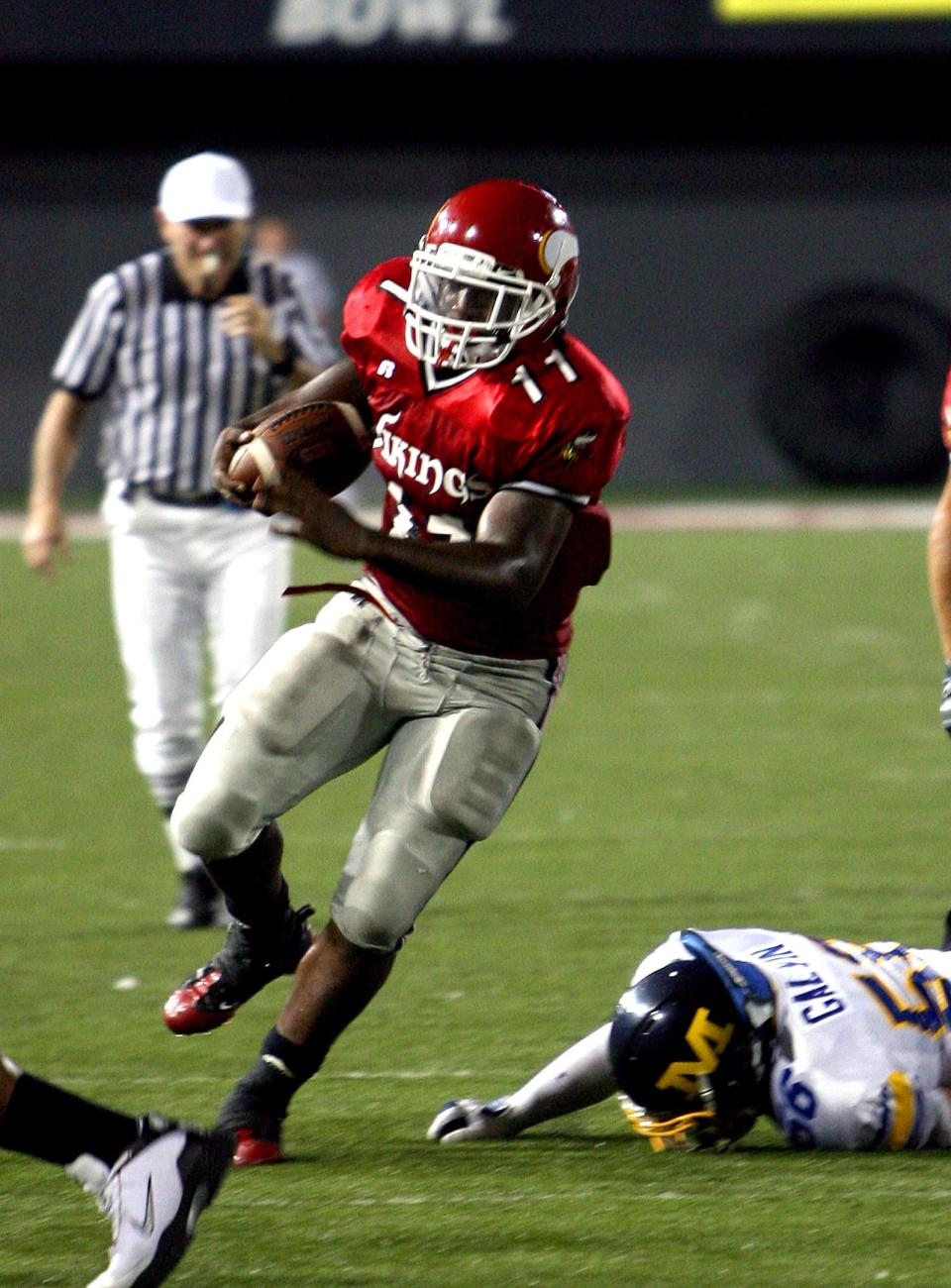 Avoiding Moeller's Nick Galvin's tackle, Princeton's Spencer Ware heads upfield against Moeller at Nippert Stadium Aug 23, 2008, in the Skyline Crosstown Showdown. Moeller won 27-17.