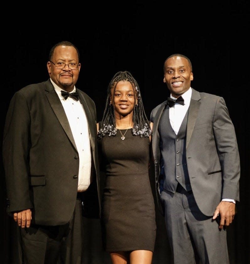 From left to right, William Lawson III, Petersburg High School Athletic Director, 2023 Donamatrix High School Athlete Awardee Brianna Smith, Petersburg High School student and Don "DB Donamatrix" Brooks, DON-A-MATRIX TRAINING Studio owner strike poses at benefit gala in Petersburg on March 31, 2023.