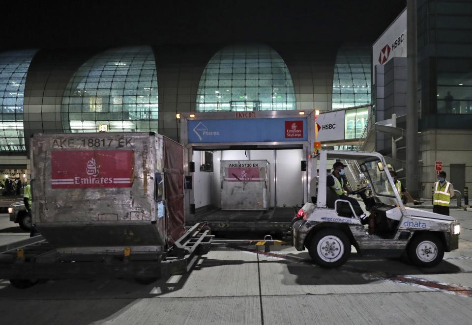 A shipment of Pfizer-BioNTech coronavirus vaccines is offloaded from an Emirates Airlines Boing 777 that arrived from Brussels to Dubai International Airport in Dubai, United Arab Emirates, Saturday, Feb. 20, 2021. As the coronavirus pandemic continues to clobber the aviation industry, Emirates Airlines, the Middle East’s biggest airline, is seeking to play a vital role in the global vaccine delivery effort. (AP Photo/Kamran Jebreili)