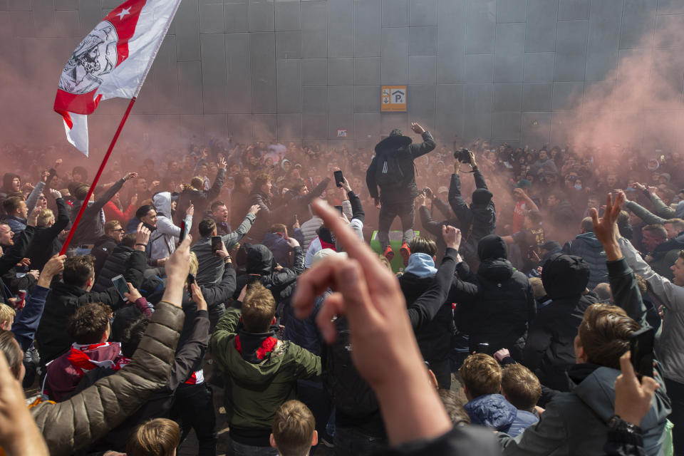 Ajax supporters celebrate outside the Arena as their team scored their second goal in the Dutch Eredivisie Premier League title during the soccer match between Ajax and Emmen at the Johan Cruyff ArenA in Amsterdam, Netherlands, Sunday, May 2, 2021. (AP Photo/Peter Dejong)