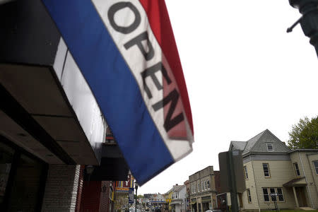 A storefront is adorned with an "open" flag in Northampton, Pennsylvania, U.S. April 24, 2017. Northampton County voted for Obama in 2008 and 2012, but Trump in 2016. REUTERS/Mark Makela