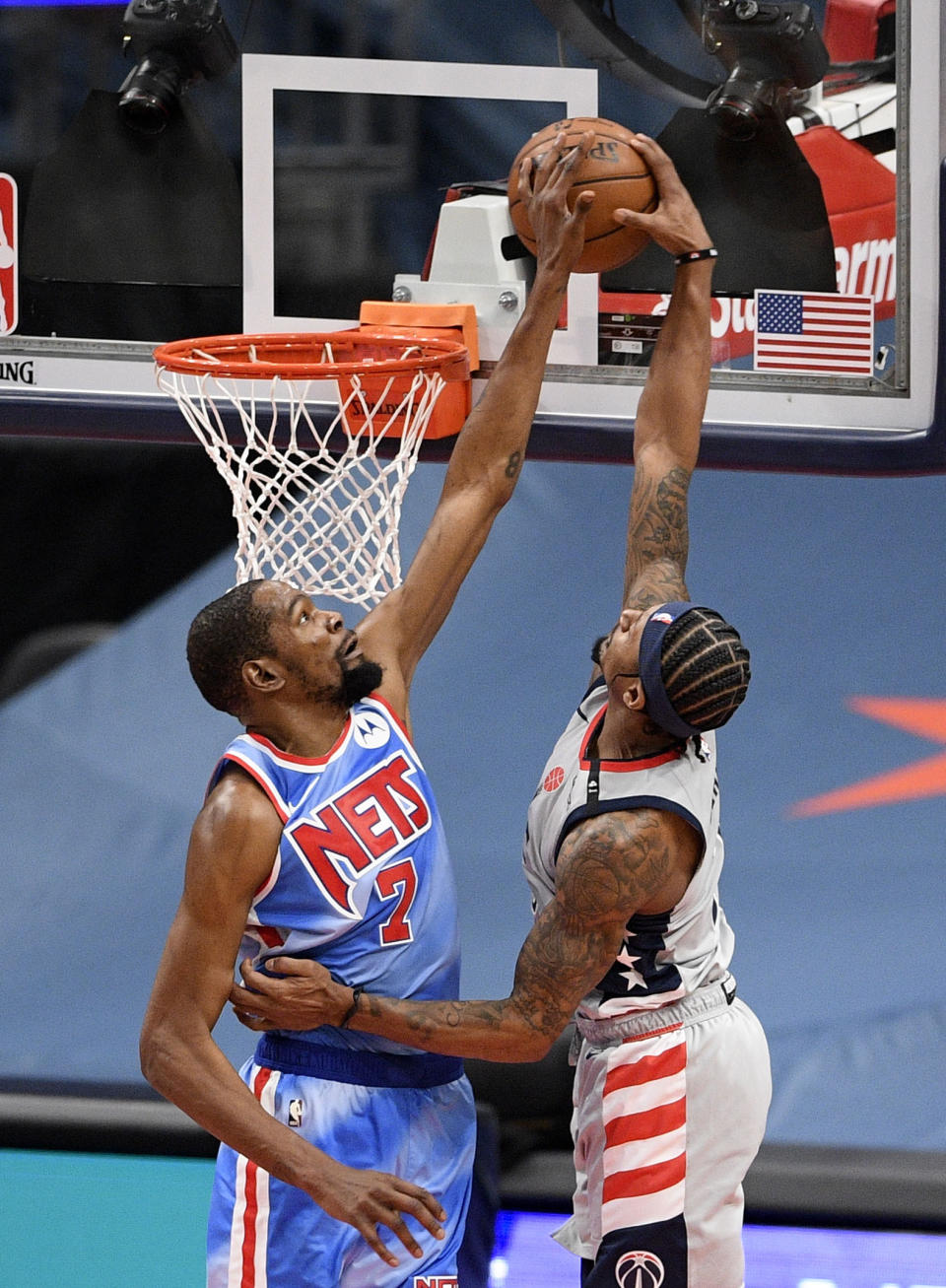 Washington Wizards guard Bradley Beal, right, goes to the basket as Brooklyn Nets forward Kevin Durant, left, defends during the second half of an NBA basketball game, Sunday, Jan. 31, 2021, in Washington. (AP Photo/Nick Wass)