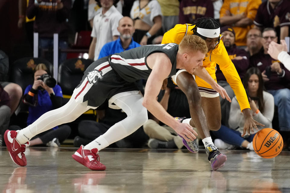 Arizona State forward Jamiya Neal, right, battles with Washington State guard Jabe Mullins, left, for a loose ball during the first half of an NCAA college basketball game in Tempe, Ariz., Thursday, Jan. 5, 2023. (AP Photo/Ross D. Franklin)