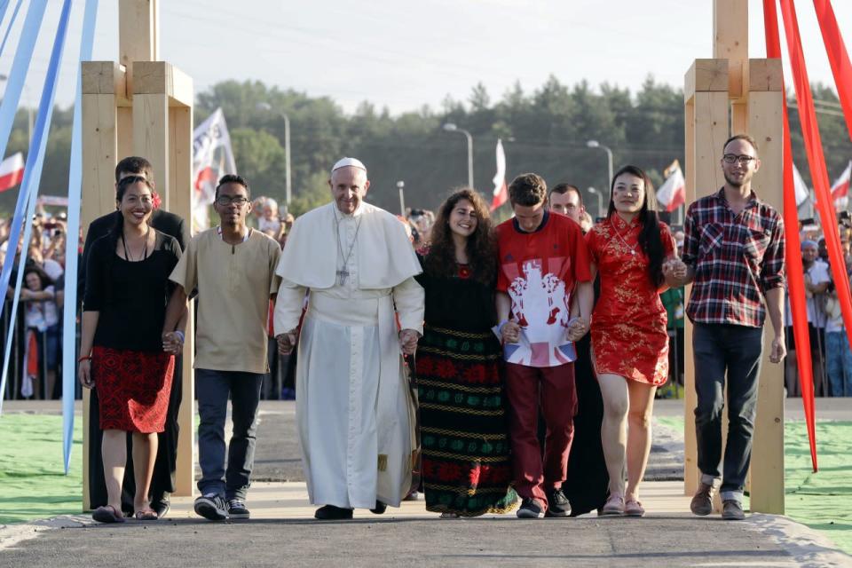 Pope Francis © with young people crosses the Gate of Mercy at the Campus Misericordiae in Brzegi, Poland, 30 July 2016, during the evening vigil with pilgrims participating in the World Youth Day 2016. (EPA/DANIEL DAL ZENNARO)