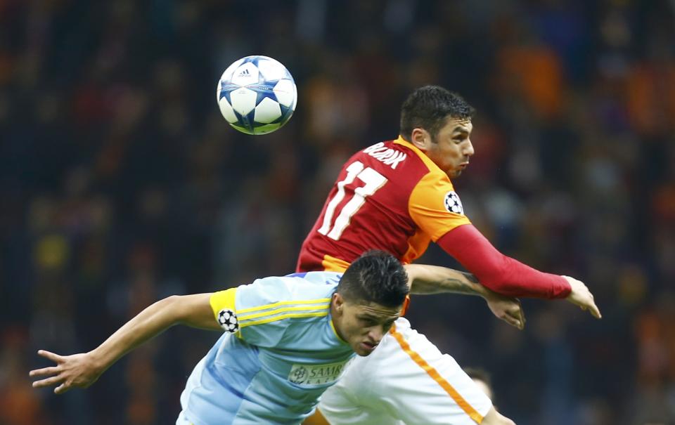 Football Soccer - Galatasaray v Astana - UEFA Champions League Group Stage - Group C - Ali Sami Yen, Istanbul, Turkey - 8/12/15 Burak Yilmaz of Galatasaray and Roger Canas of Astana in action. REUTERS/Osman Orsal