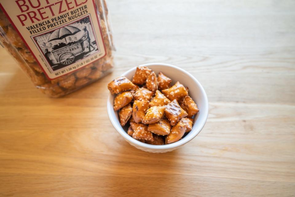 peanut-butter-filled pretzels in a bowl next to container from costco