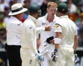 Umpire Marais Erasmus (L) intervenes to stop an argument between Australia's captain Michael Clarke (2nd L) and teammate Brad Haddin with England's Ben Stokes (2nd R) after the replay announcing Haddin is not out due to a no ball during the second day of the second Ashes test cricket match at the Adelaide Oval December 6, 2013.